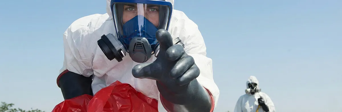 sewage clean up technician wearing protective gear handling biohazard materials in Peoria, IL