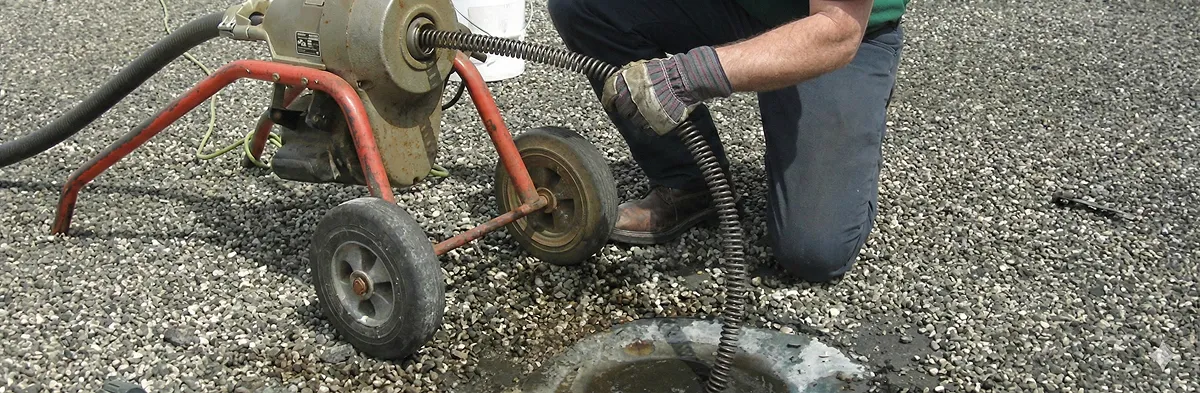 sewer rodding technician actively removing blockages from a sewer line in Peoria, IL