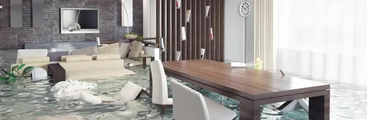 home interior affected by water damage with flooded floors and displaced furniture in Peoria, IL